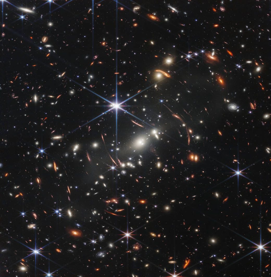 SMACS 0723: Massive foreground galaxy clusters magnify and distort the light of objects behind them, permitting a deep field view into both the extremely distant and intrinsically faint galaxy populations.