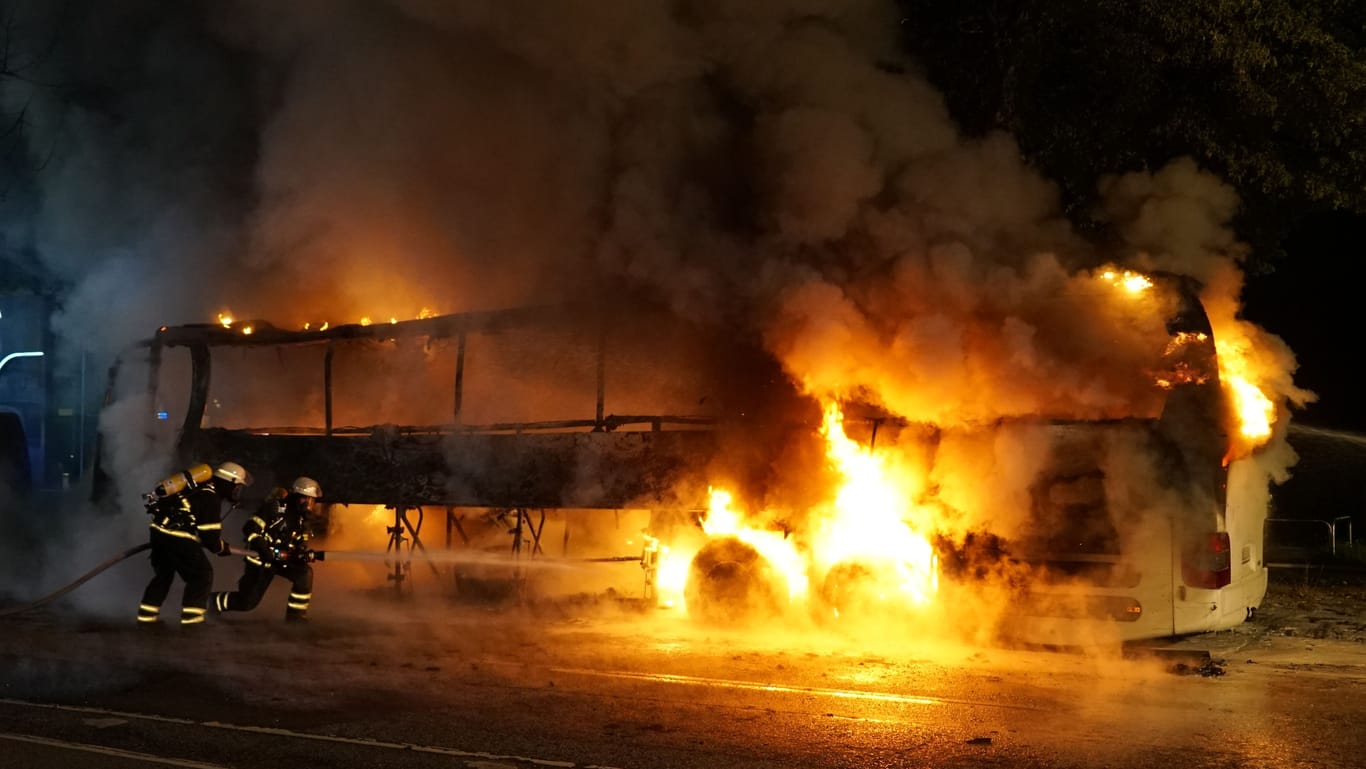 Der in Flammen stehende Bus: Auch mehrere weitere Fahrzeuge wurden beschädigt.