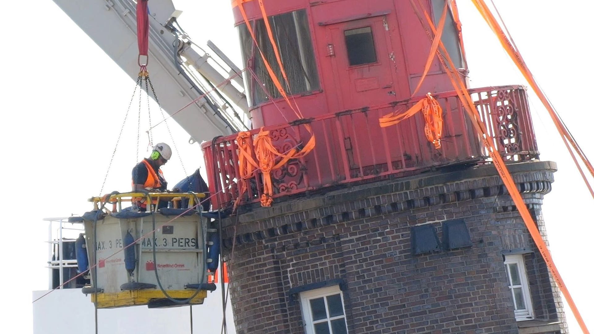Ein Arbeiter an der Kuppel des schiefen Leuchtturms auf der Mole in Bremerhaven. Ein Arbeiter an der Kuppel des schiefen Leuchtturms auf der Mole in Bremerhaven.