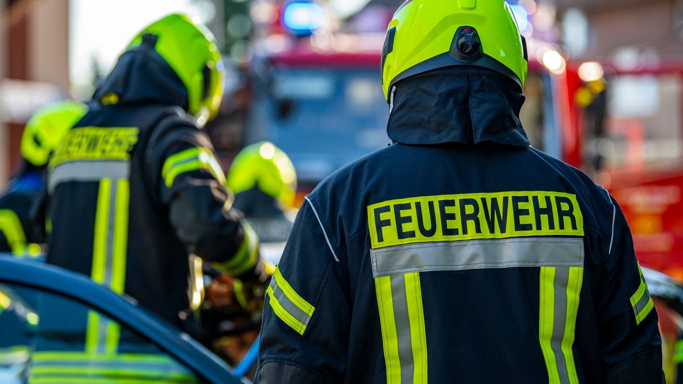Feuerwehrleute stehen um ein Auto, das einen Unfall gehabt hat (Symbolbild): In Hamburg gibt es keine Nachwuchssorgen.