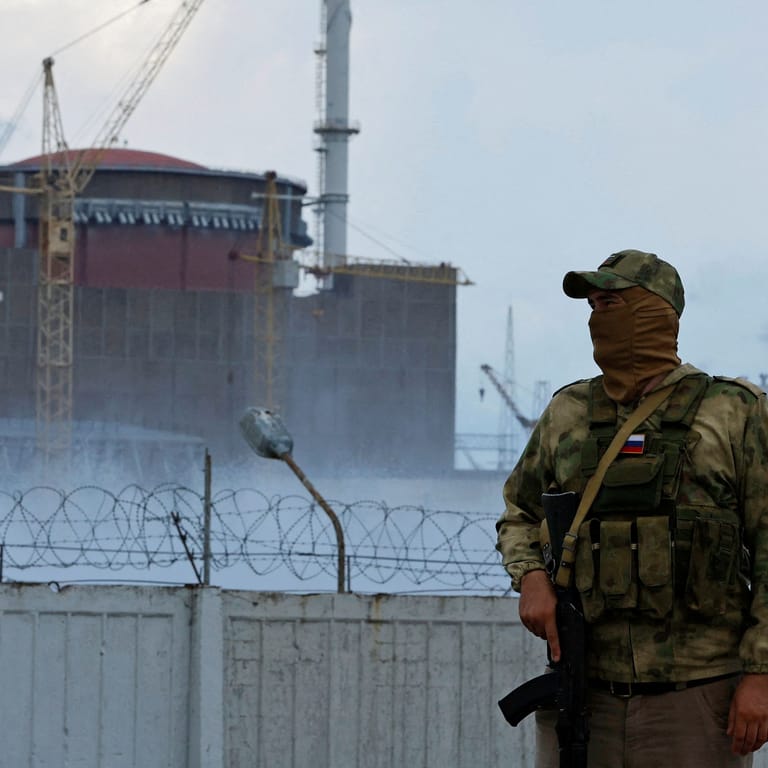 FILE PHOTO: A serviceman with a Russian flag on his uniform stands guard near the Zaporizhzhia Nuclear Power Plant in the course of Ukraine-Russia conflict outside the Russian-controlled city of Enerhodar in the Zaporizhzhia region, Ukraine August 4, 2022.