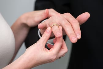 Braut steckt Bräutigam den Ehering an (Symbolbild): Nach der Heirat wechseln Ehepartner automatisch die Steuerklasse.