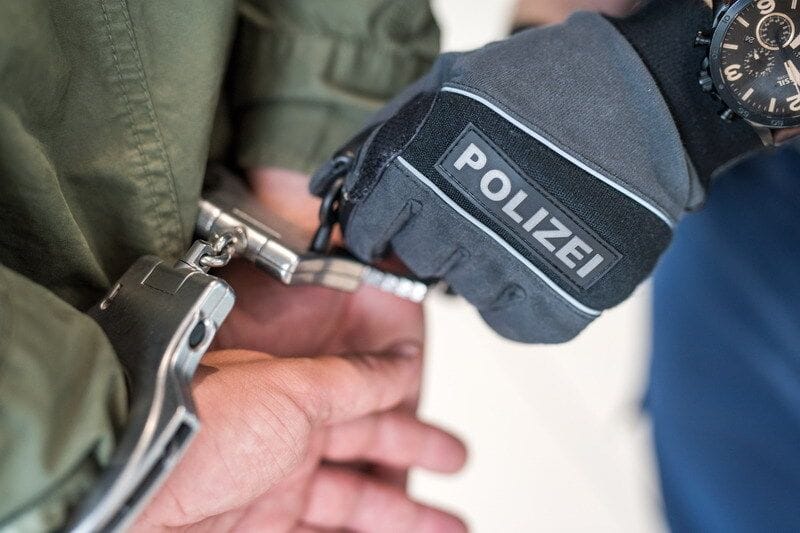 Ein Polizist legt einer Person Handschellen an (Symbolbild): Die Frau wurde lebensgefährlich verletzt.