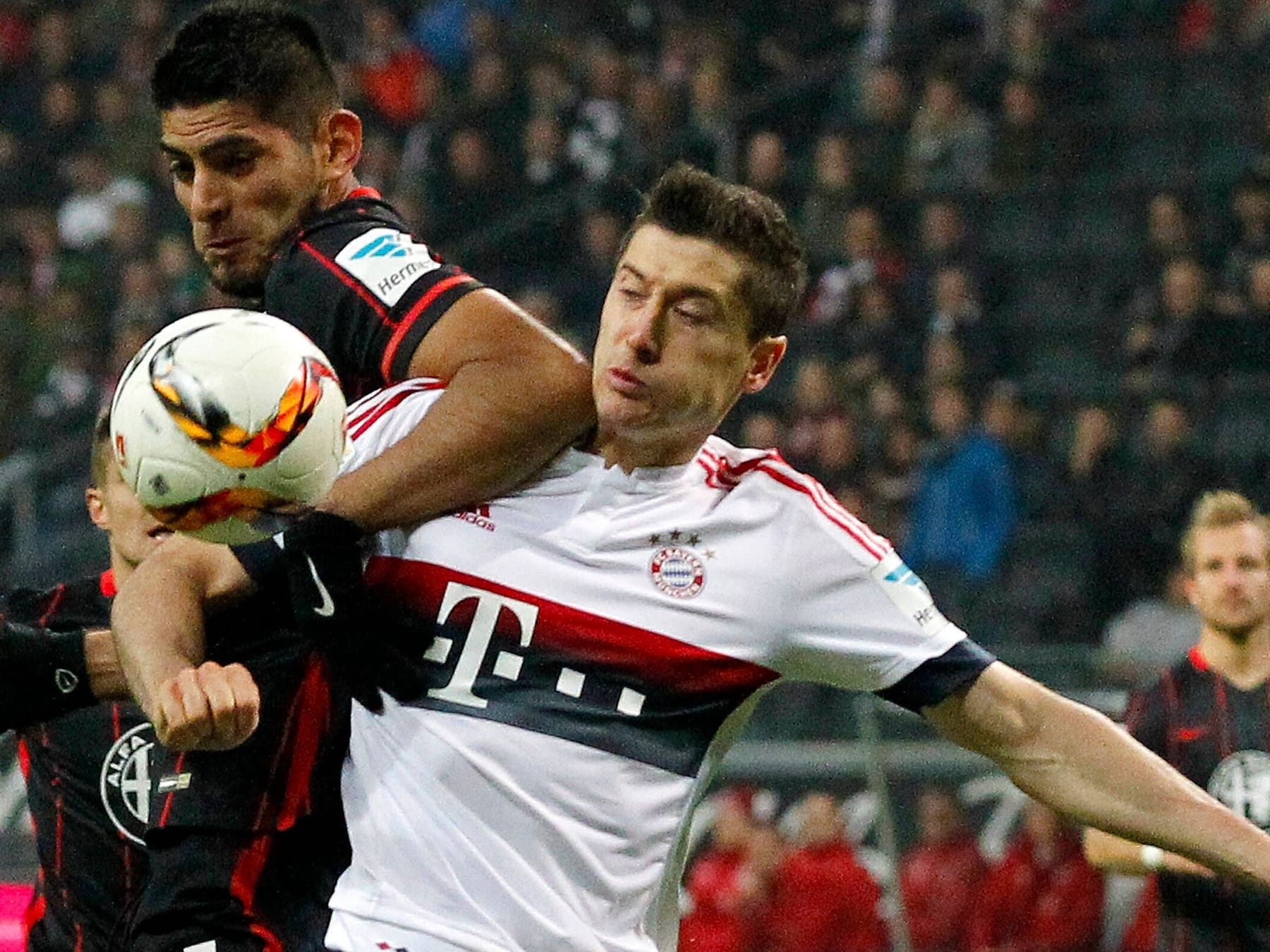 Frankfurt's Carlos Zambrano (L) and Munich's Robert Lewandowski