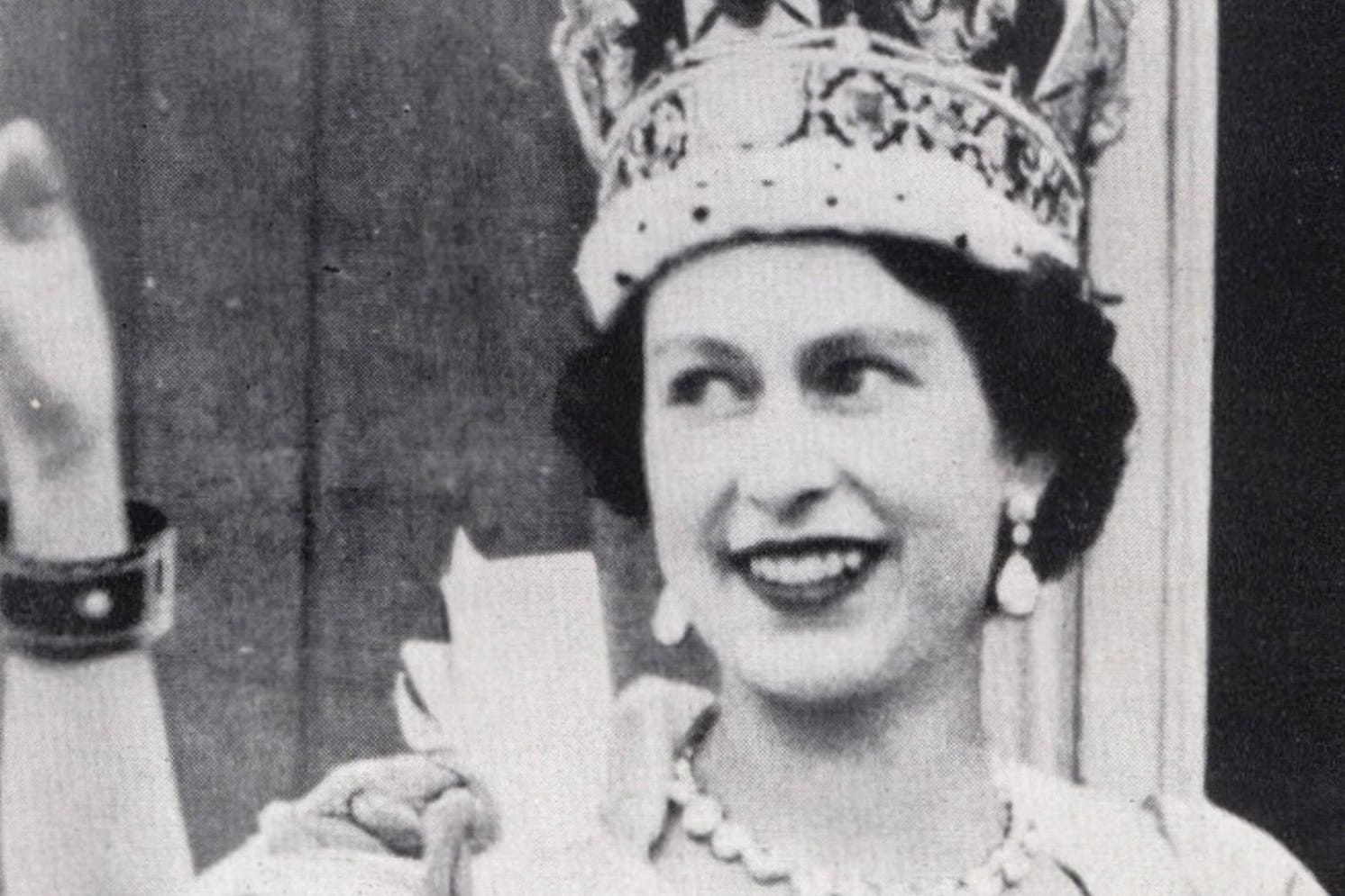 Queen Elizabeth II and Prince Phillip wave from Buckingham Palace in London following the coronation