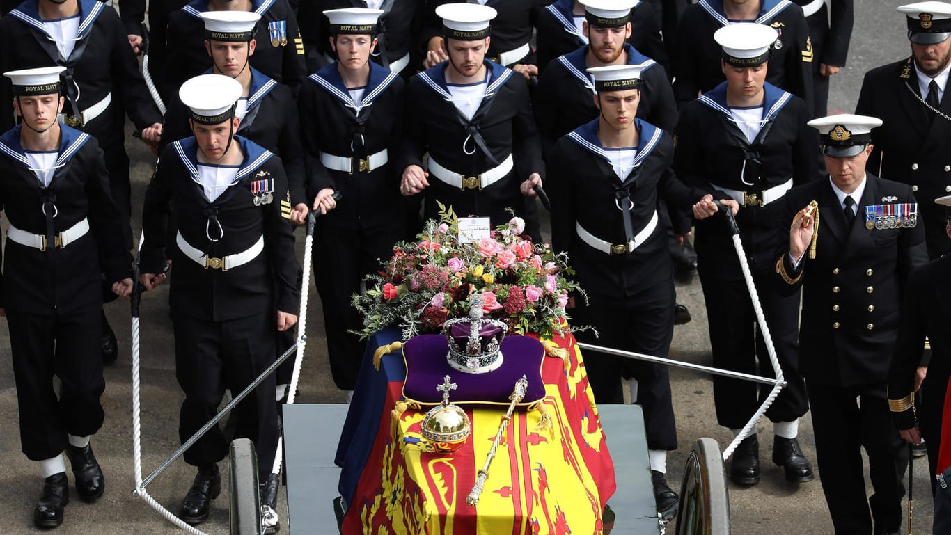 The State Gun Carriage carries the coffin of Queen Elizabeth II, draped in the Royal Standard with the Imperial State Cr