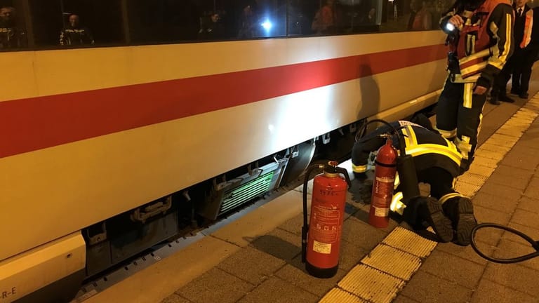 Einsatzkräfte der Feuerwehr überprüfen einen Zug in Bochum: Der Zug hatte während der Fahrt Feuer gefangen.