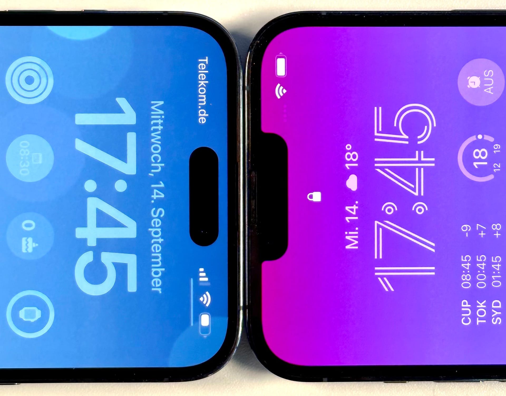 iPhone 14 Pro Max (links) und iPhone 13 Pro Max. Statt der "Notch", der Aussparung im Bildschirm rechts, gibt es nun einen pillenförmigen Ausschnitt im Display.