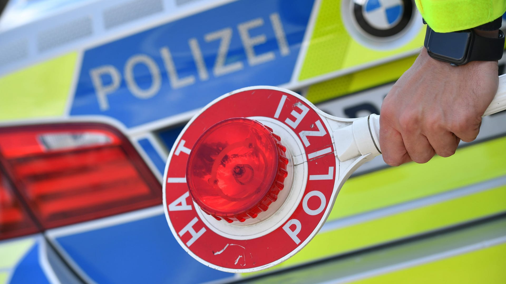 Ein Polizist hält eine Stopp-Kelle in der Hand (Symbolbild): Der Angreifer wollte sich der Kontrolle entziehen, Ein Polizist hält eine Stopp-Kelle in der Hand (Symbolbild): Der Angreifer wollte sich der Kontrolle entziehen,