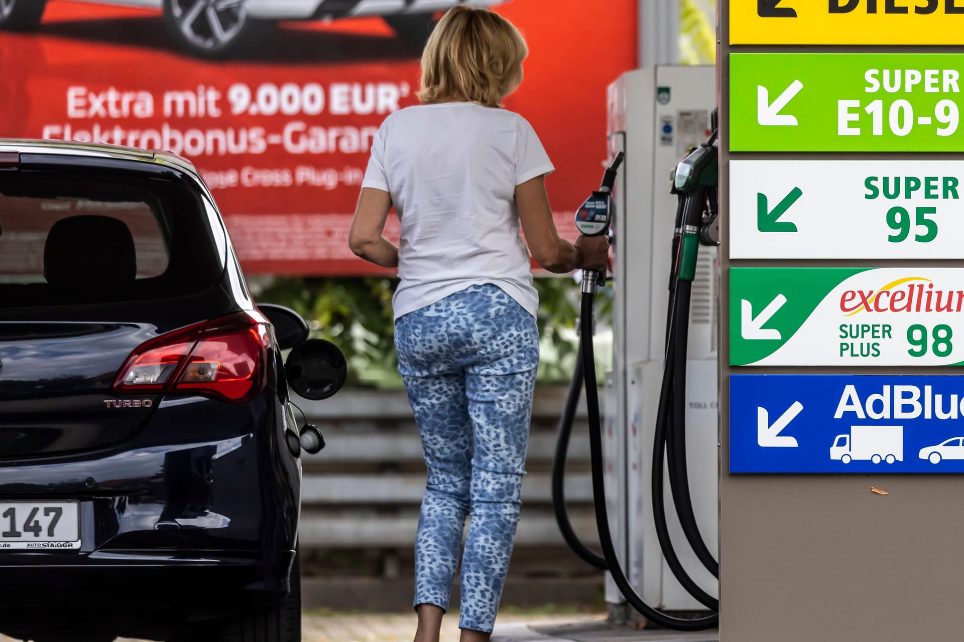Eine Frau betankt einen Wagen: