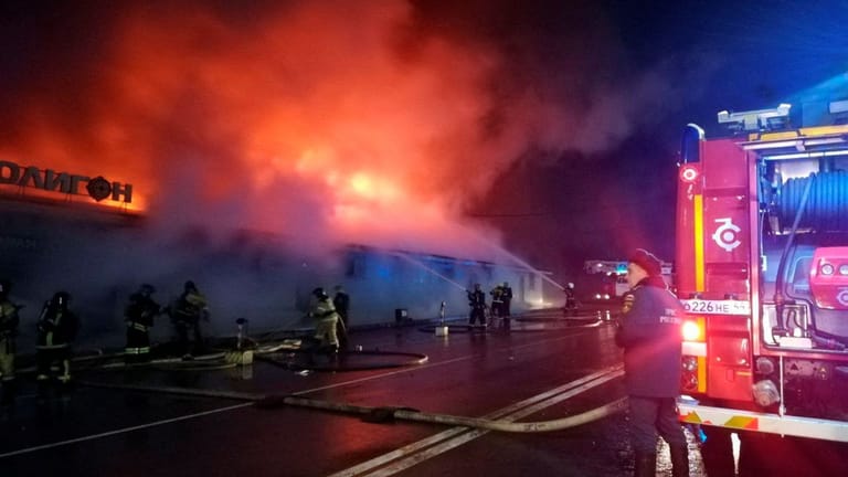 Firefighters work to extinguish a fire at a cafe in Kostroma