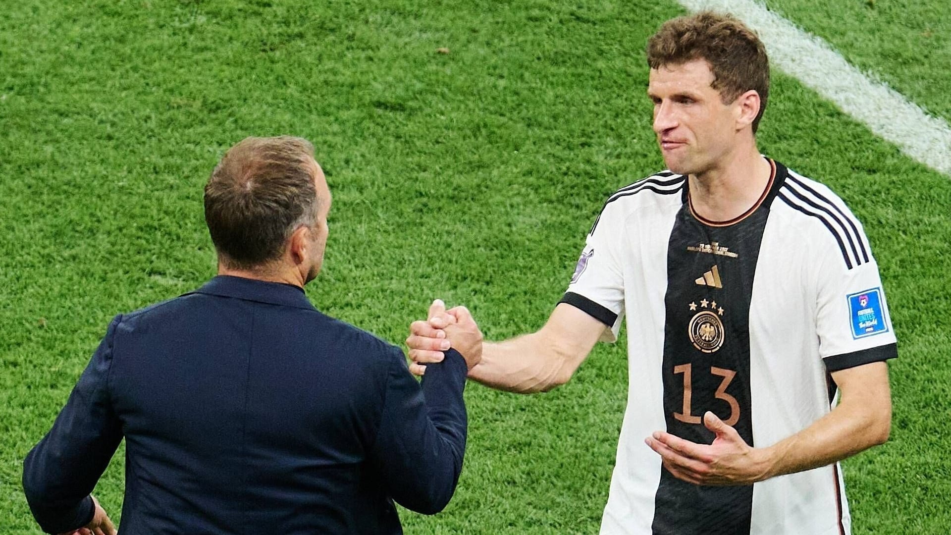 Hansi Flick und Thomas Müller auf dem Spielfeld.