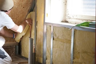 Handwerker bei der Arbeit (Symbolbild): Wer sein Dach dämmt, spart Heizkosten – und kann den Staat an den Kosten beteiligen.