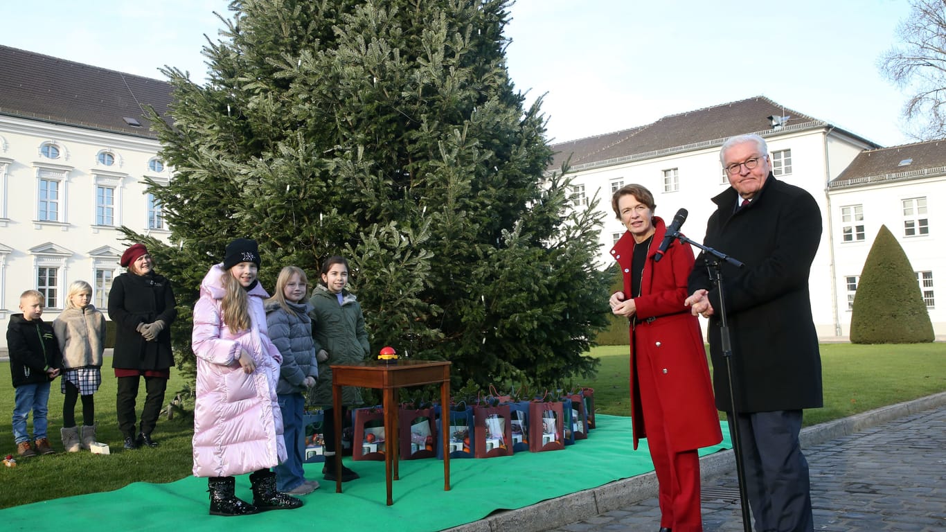 Bundespräsident Frank-Walter Steinmeier und seine Frau Elke Büdenbender entzünden gemeinsam mit Schülern die Lichter am Weihnachtsbaum vor dem Schloss Bellevue (Archivbild).