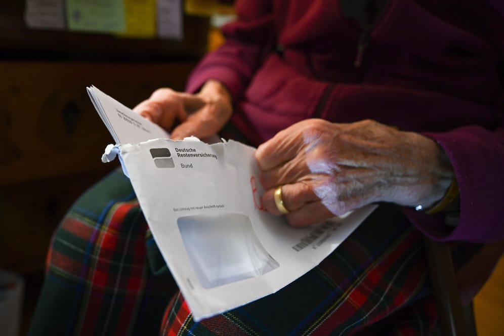 Eine Seniorin hält ihren Rentenbescheid (Symbolbild): Für Menschen, die schon vor der Altersrente eine Erwerbsminderungsrente beziehen, gelten andere steuerliche Regeln.