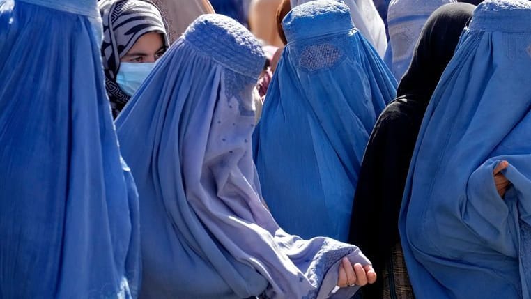 Frauen in Burkas warten im Sommer in Kabul auf Lebensmittelrationen: Das Bildungsverbot für Frauen trifft alle privaten und öffentlichen Universitäten und Hochschulen.