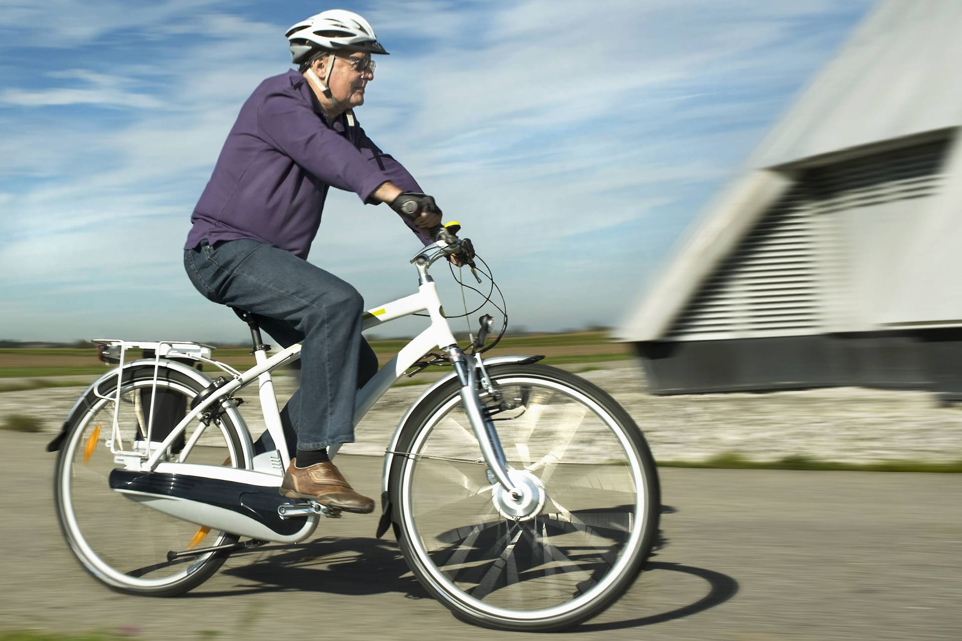 Ein älterer Mann fährt auf einem E-Bike.