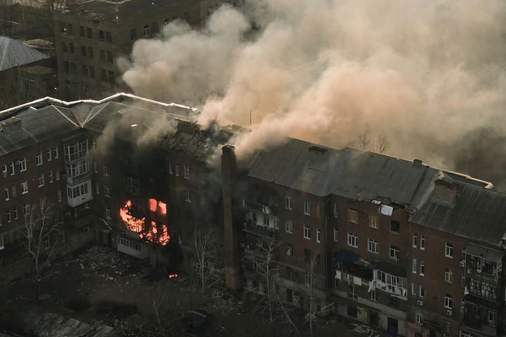 Ein Wohnhaus steht nach einem Beschuss in Flammen.