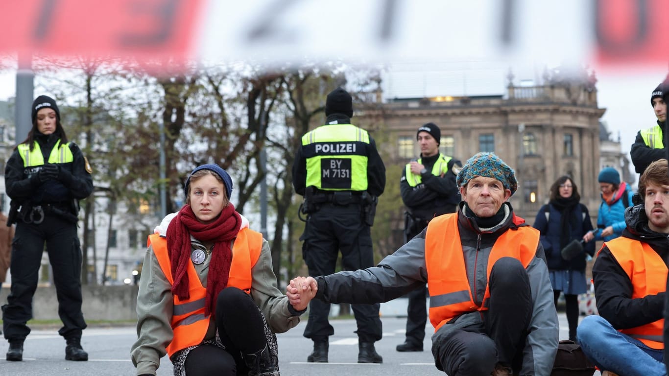 Aktivisten der "Letzten Generation" und Polizisten am Stachus in München: Die Straßenblockade am Montag war zuvor angekündigt und konnte dennoch wie geplant durchgeführt werden.