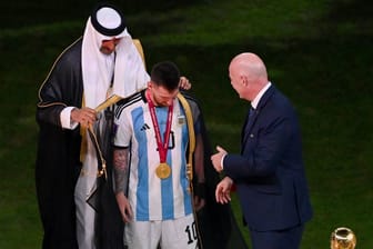 Lionel Messi bekommt bei der WM-Pokalübergabe den Bischt umgehängt: Ein Anwalt will das Kleidungsstück kaufen.
