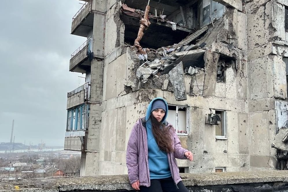 Sofia Makeeva posiert vor einem Haus in Mariupol.