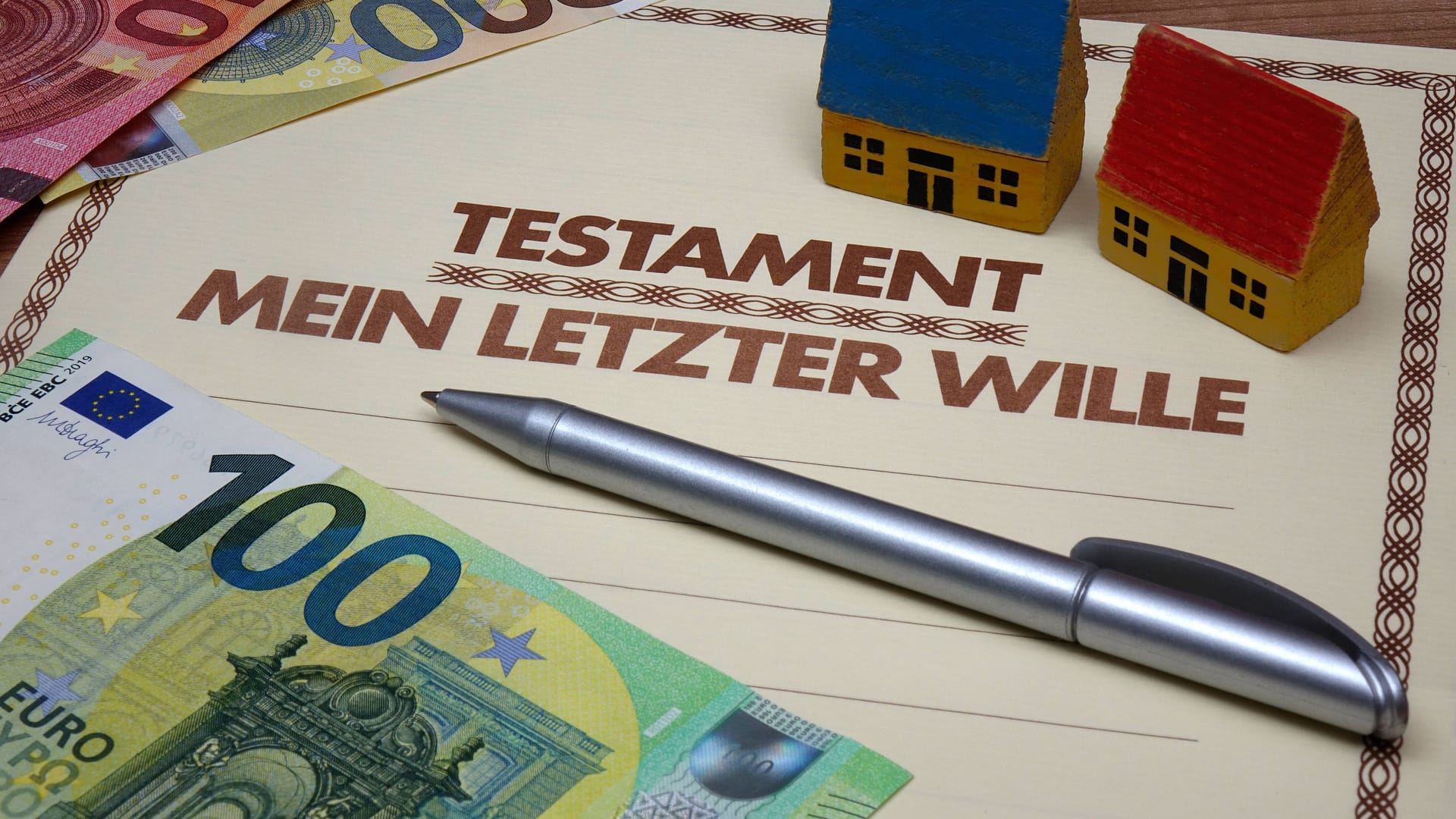 Testament mit Geldscheinen und Holzhäuschen (Symbolbild): Nach einem Urteil bleibt einem Mann sein erhofftes Vermögen verwehrt. Testament mit Geldscheinen und Holzhäuschen (Symbolbild): Nach einem Urteil bleibt einem Mann sein erhofftes Vermögen verwehrt.