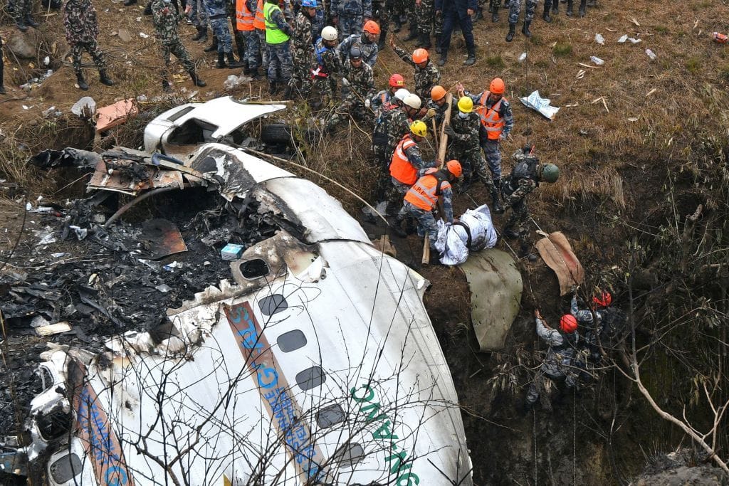 Rettungskräfte ziehen eine Leiche aus der Unfallstelle: Insgesamt 67 Menschen starben bei dem Absturz.