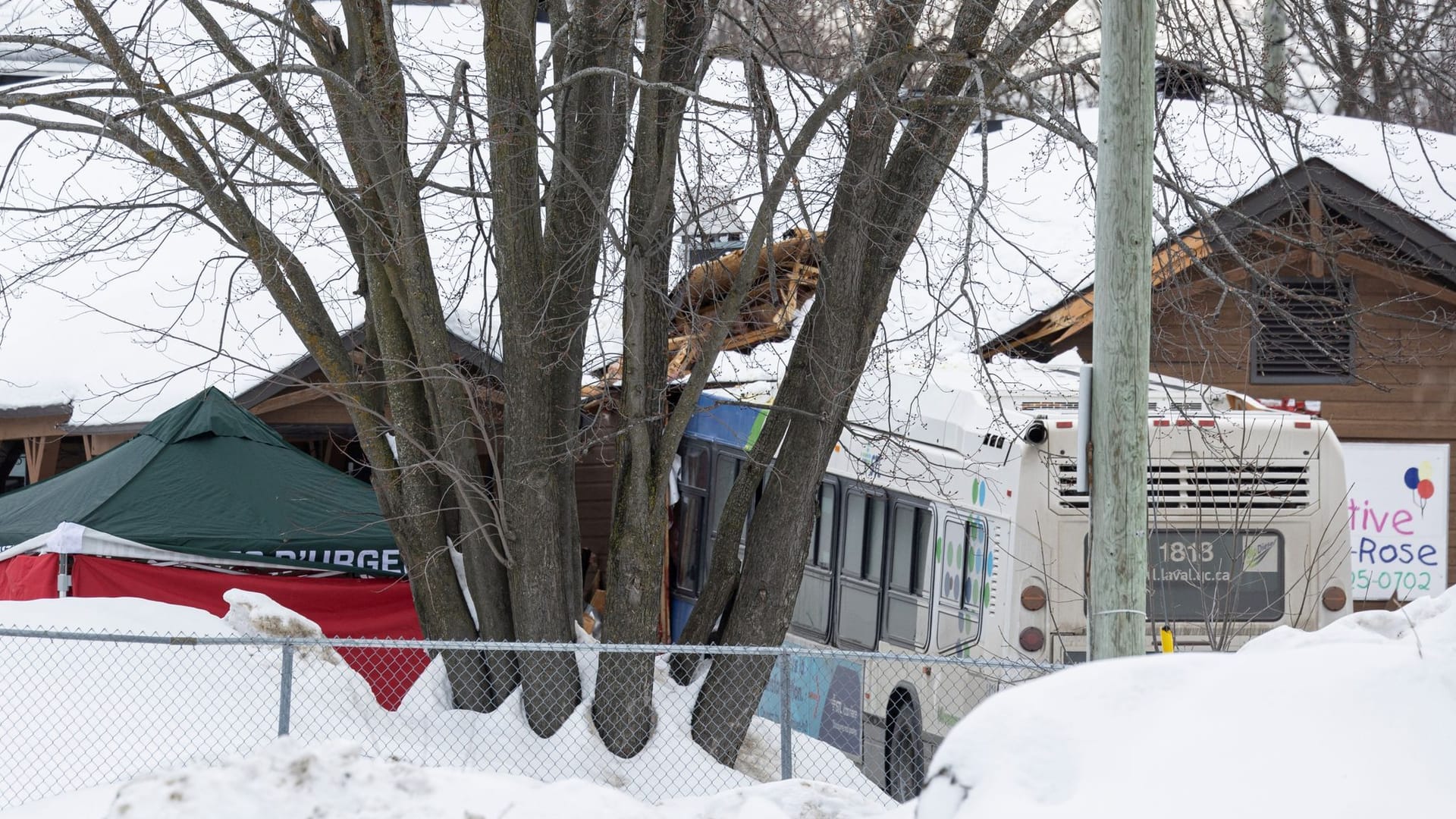 A Laval city bus is seen crashed into a daycare in Laval, Quebec