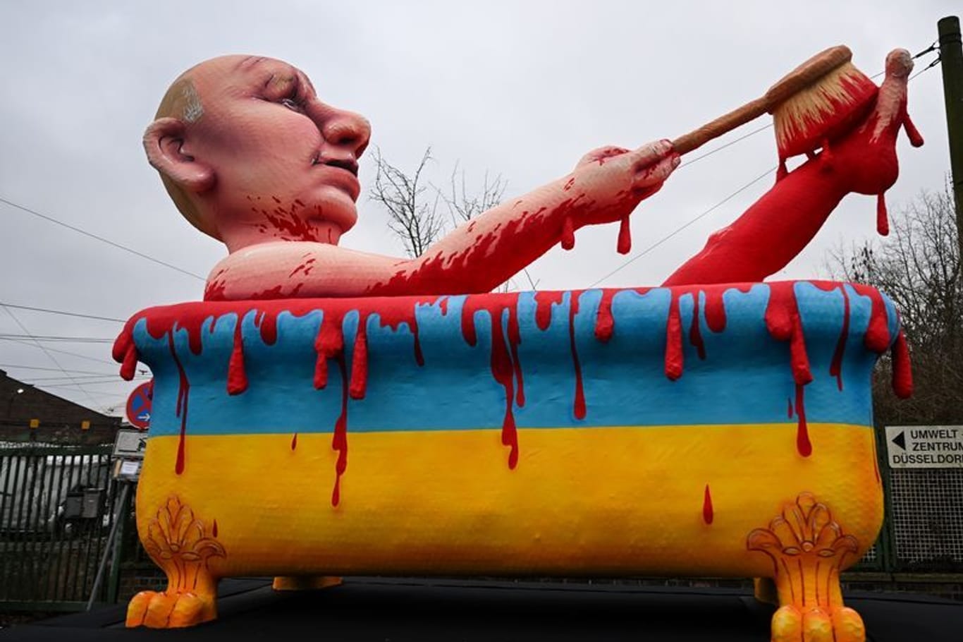 Rosenmontagsumzug in Düsseldorf: Ein Mottowagen zeigt den russischen Präsidenten, der in einer Badewanne in den ukrainischen Nationalfarben ein "Blutbad" nimmt.