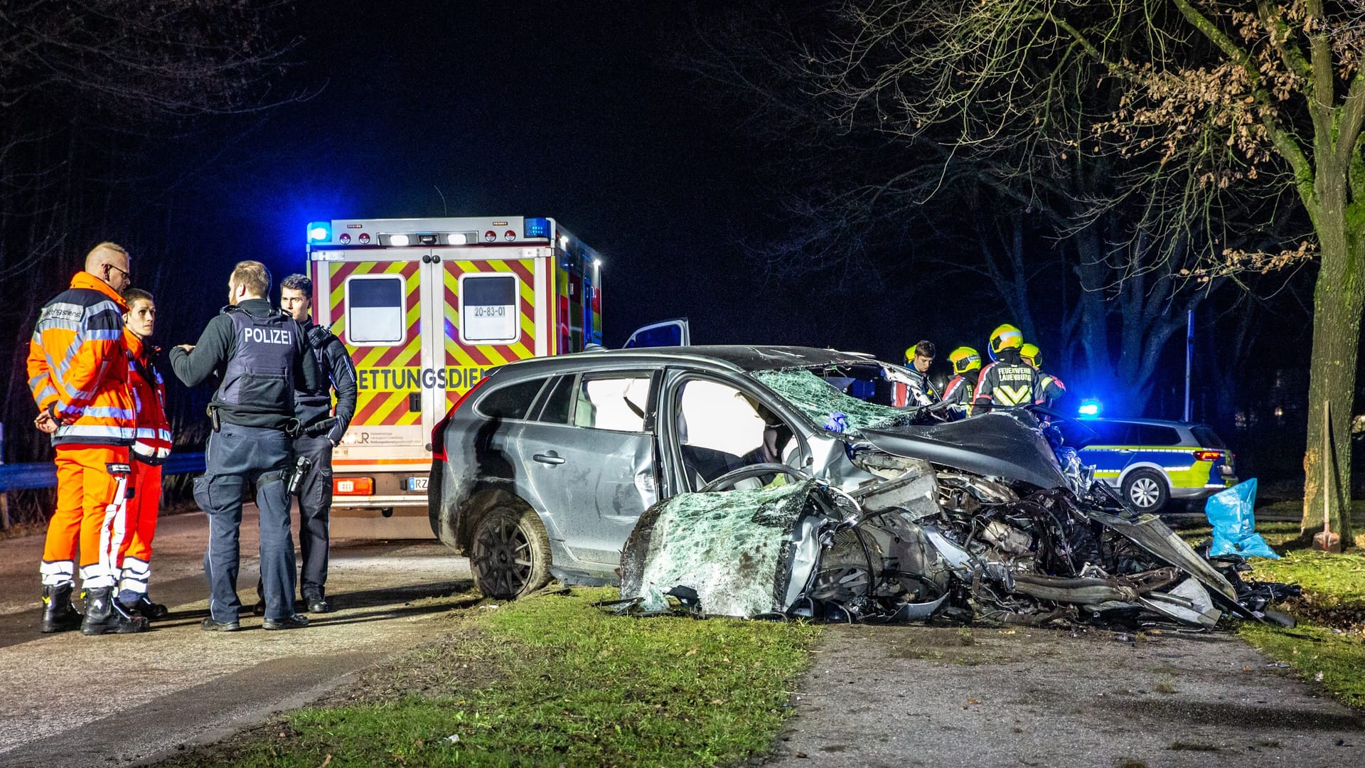 Einsatzkräfte stehen nehmen dem völlig zerstörten Pkw: Für den Fahrer kam jede Hilfe zu spät.