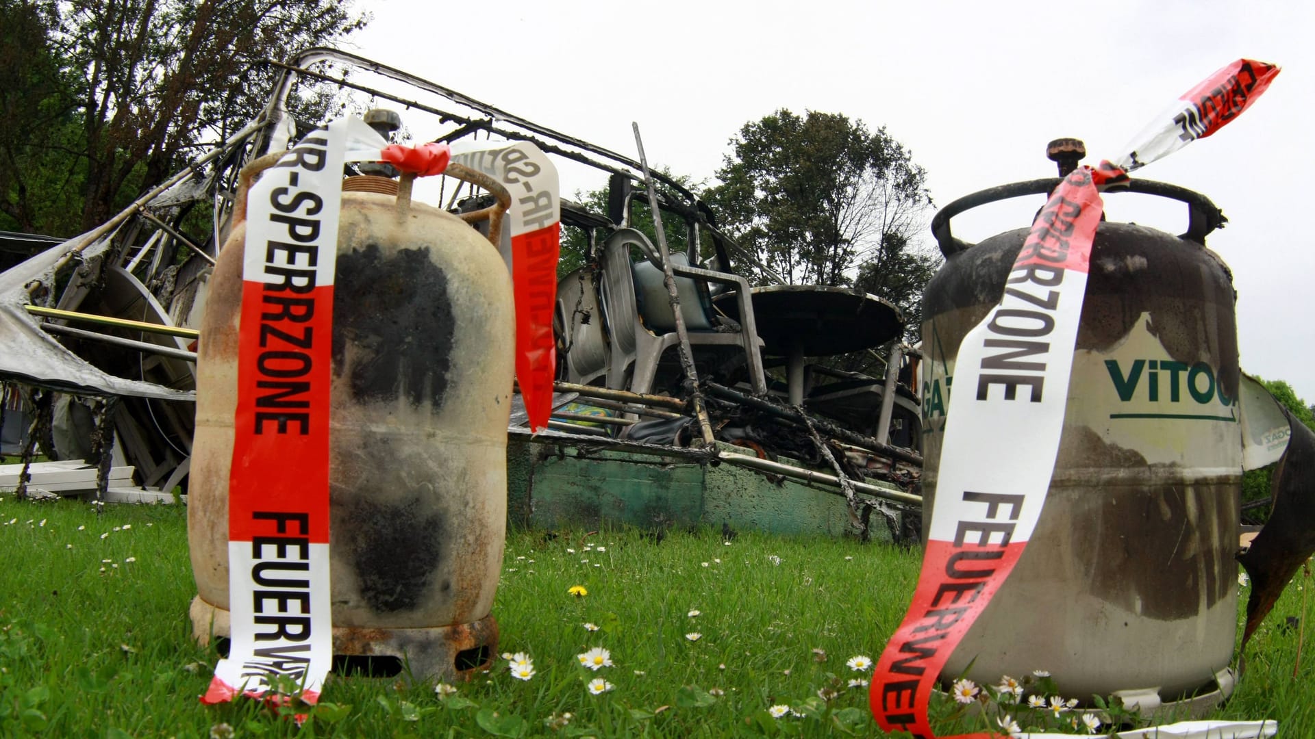 Gasflaschen vor einem zerstörten Wohnwagen (Archivbild): Das Feuer breitete sich aus. Gasflaschen vor einem zerstörten Wohnwagen (Archivbild): Das Feuer breitete sich aus.