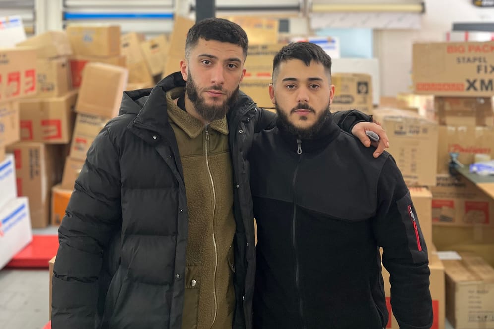 Mert Can Erdagi (links) und Mehmet Yildirim stehen in der Lagerhalle vor den Spenden: Innerhalb weniger Tage haben sie mehr als 600 Kisten gepackt.