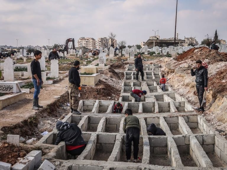 Gräber für die Erdbebenopfer (Archivbild): Syrer präparieren entlang der türkisch-syrischen Grenze Gräber für ihre Angehörigen, die bei dem Erdbeben gestorben sind.