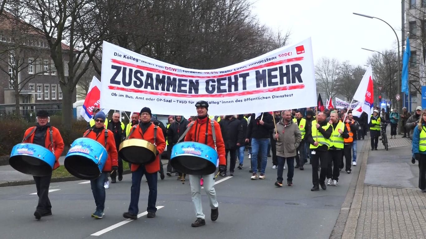 Klimaprotestierende ziehen gemeinsam mit Mitarbeitenden des öffentlichen Nahverkehrs über den Dortmunder Wall: Sie wollen auf die Verkehrswende aufmerksam machen.