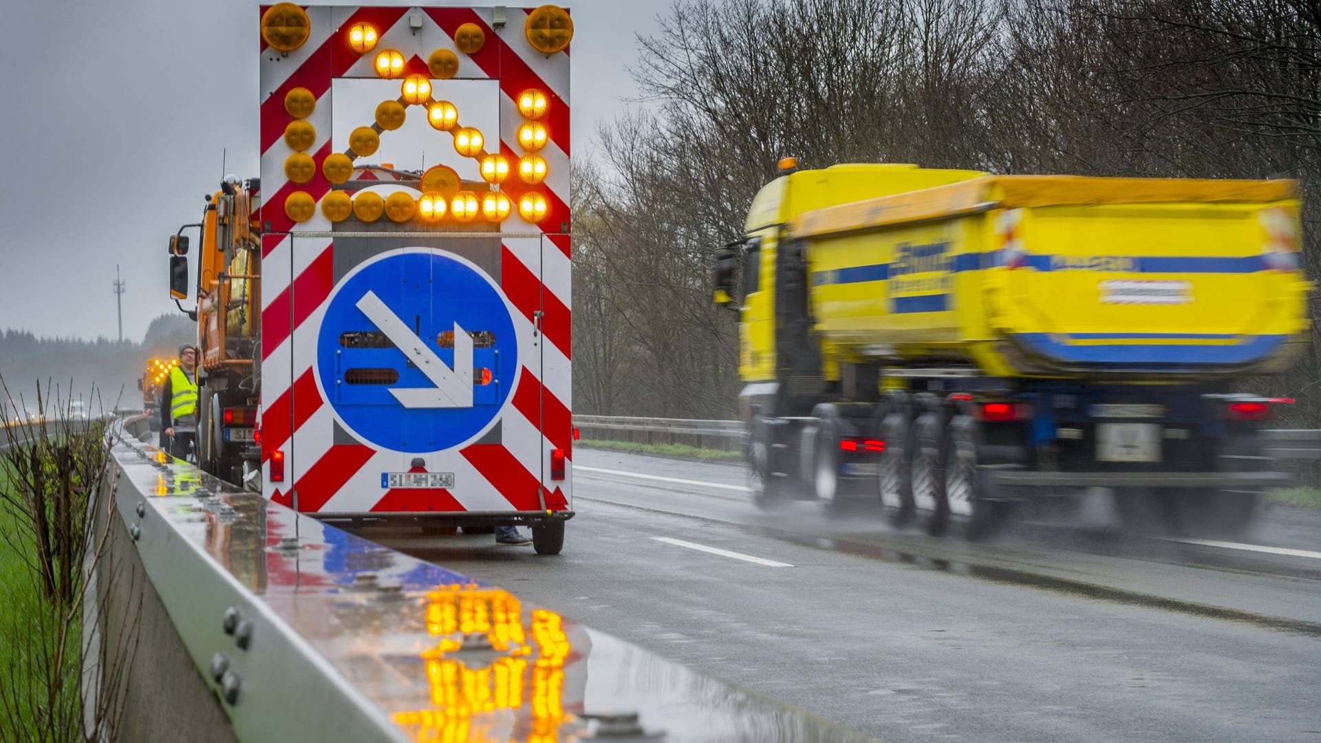 Warnhinweis Spurwechsel an einem Fahrzeug der Autobahnmeisterei auf der Autobahn A4 bei Regen, Deutschland Warnhinweis Spurwechsel an einem Fahrzeug der Autobahnmeisterei auf der Autobahn A4 bei Regen, Deutschland