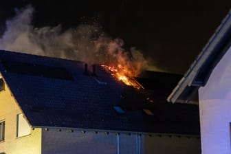 Flammen schlagen aus dem Wohnhausdach: Die Feuerwehr hatte Schwierigkeiten, in den Spitzboden mit dem Brandherd vorzudringen.