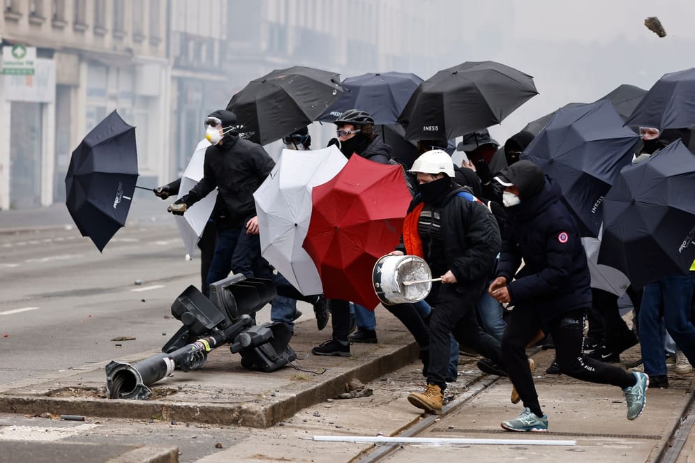 Proteste in Nantes: Demonstranten schützen sich mit Regenschirmen vor dem Tränengas der Polizei.