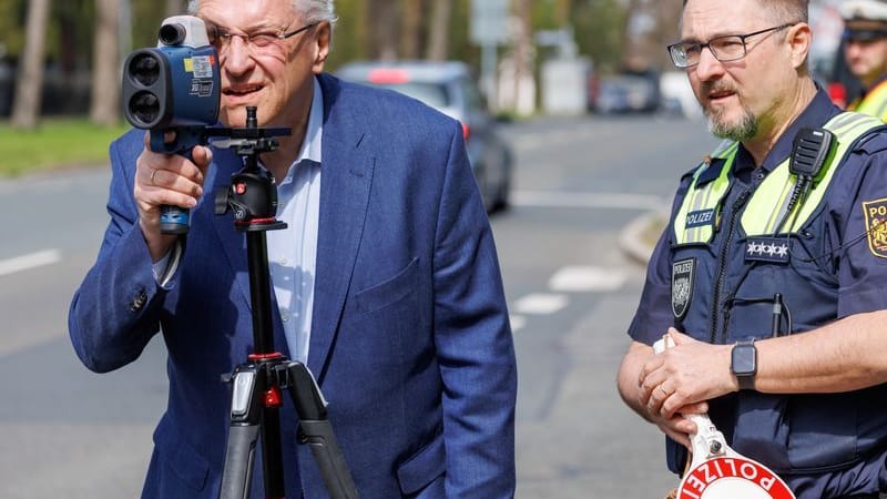 Blitzermarathon 2023: Innenminister Joachim Herrmann (links) schaut neben Hauptkommissar Dirk Klinge von der Verkehrspolizeiinspektion Nürnberg durch ein Laserhandmessgerät.