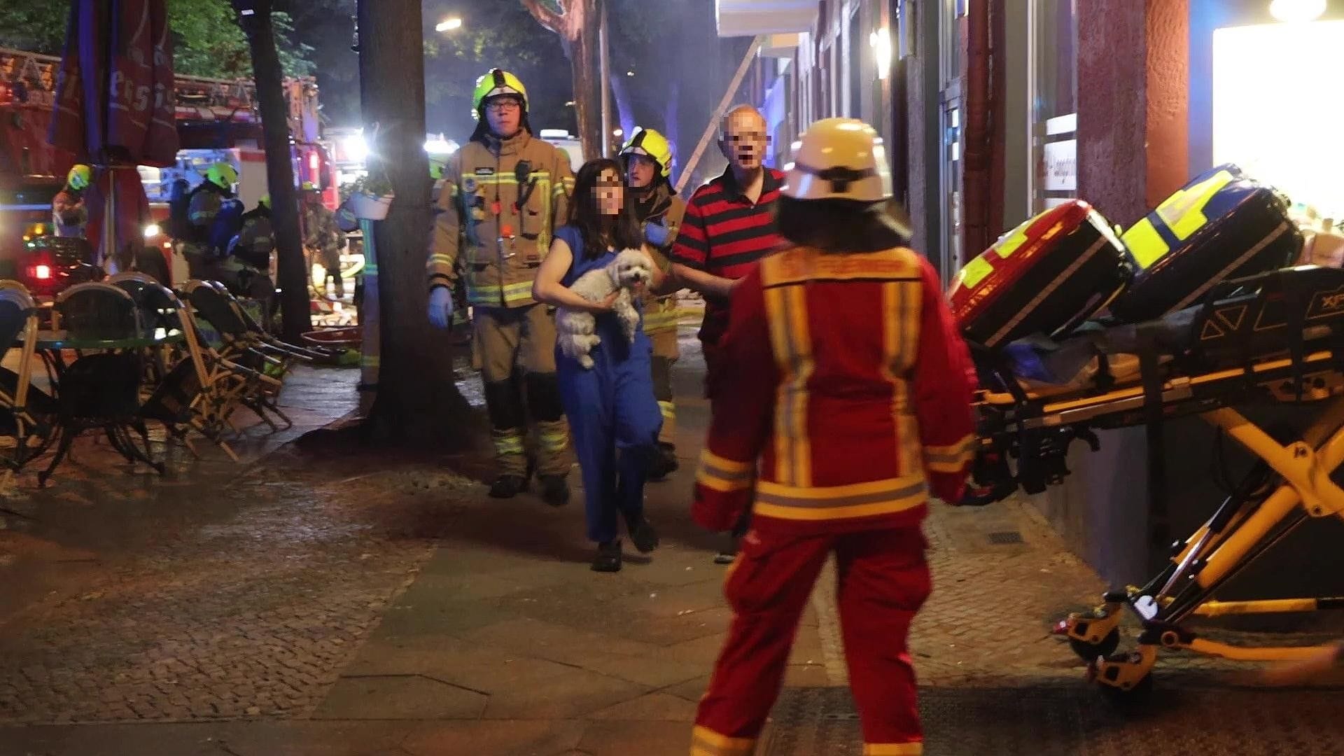 Bewohner des Brandhauses auf der Flucht vor den Flammen.