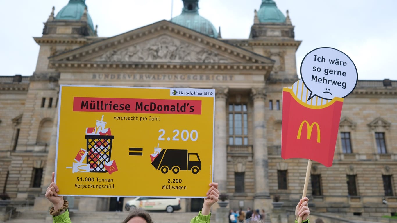 Aktivistinnen der Deutschen Umwelthilfe stehen mit Transparenten vor dem Bundesverwaltungsgericht in Leizig: Dort wurde die Klage von McDonald's gegen die Tübinger Verbrauchssteuer für Einweg-to-Go-Verpackungen verhandelt.