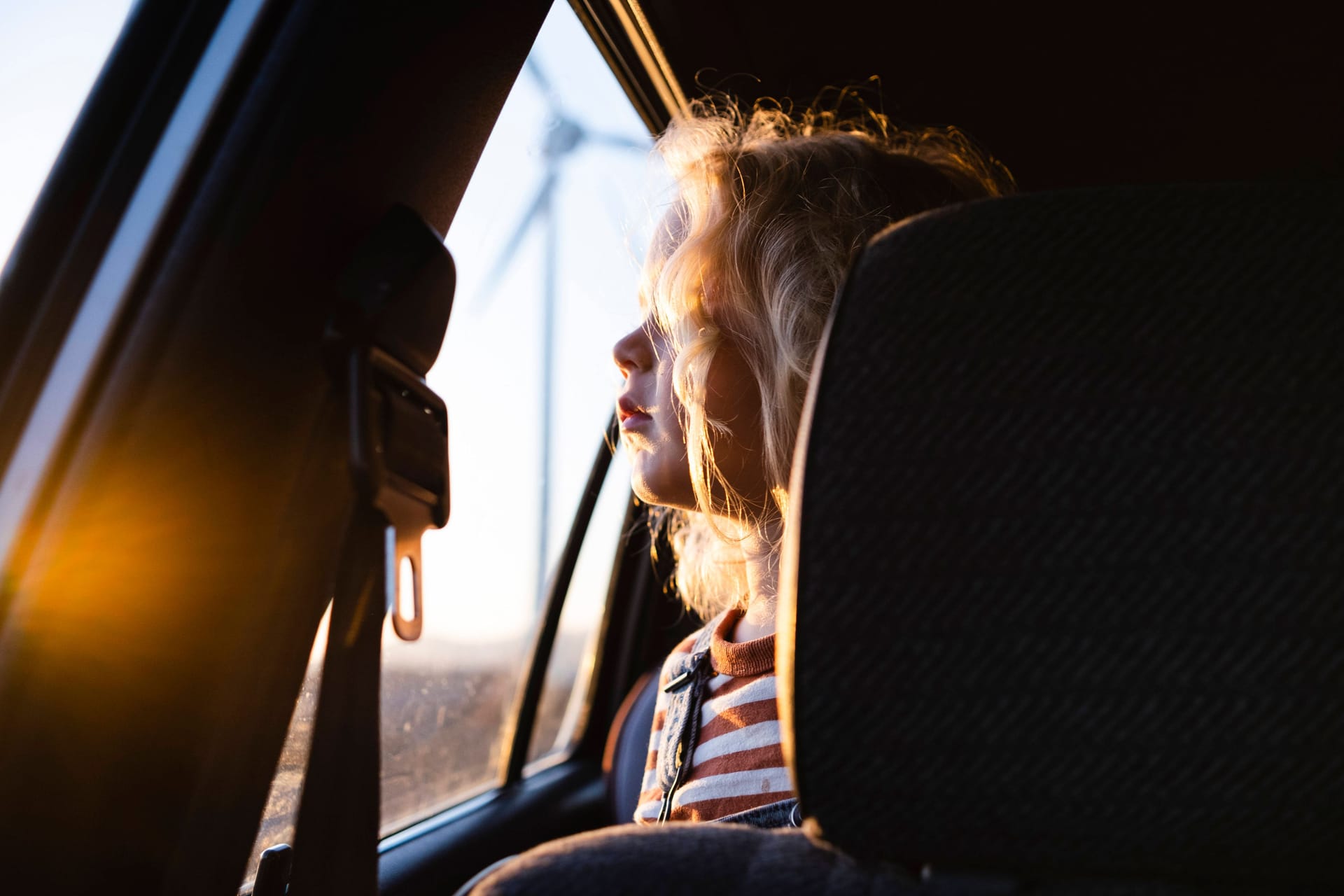 Ein kleines Kind guckt aus einem Auto hinaus (Archivbild): In Hildesheim hat eine Mutter ihr Kind versehentlich im Auto eingesperrt.