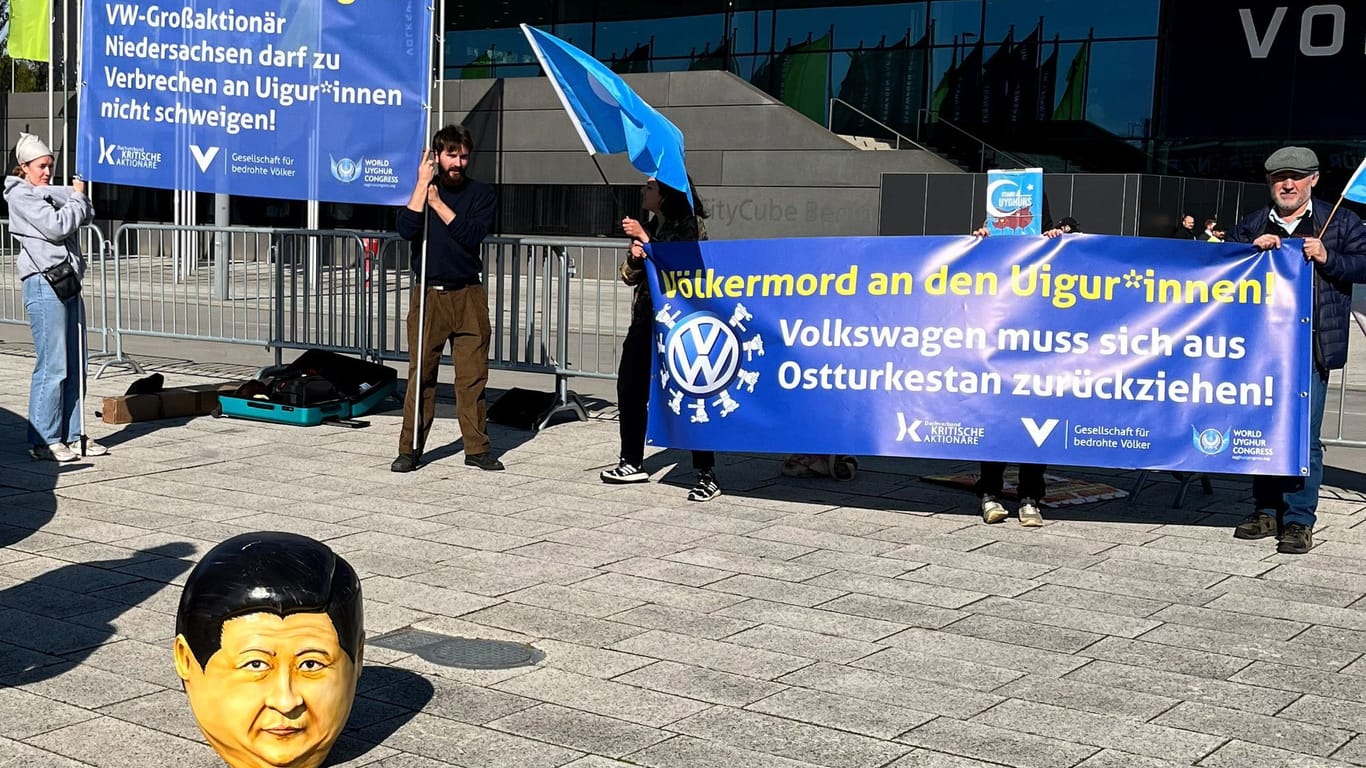Activists protest before the annual general Volkswagen meeting in Berlin