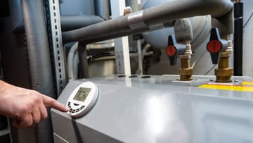 Air source heat pump in a boiler room: It draws heat from the outside air and uses it to heat the water in the radiators or underfloor heating.