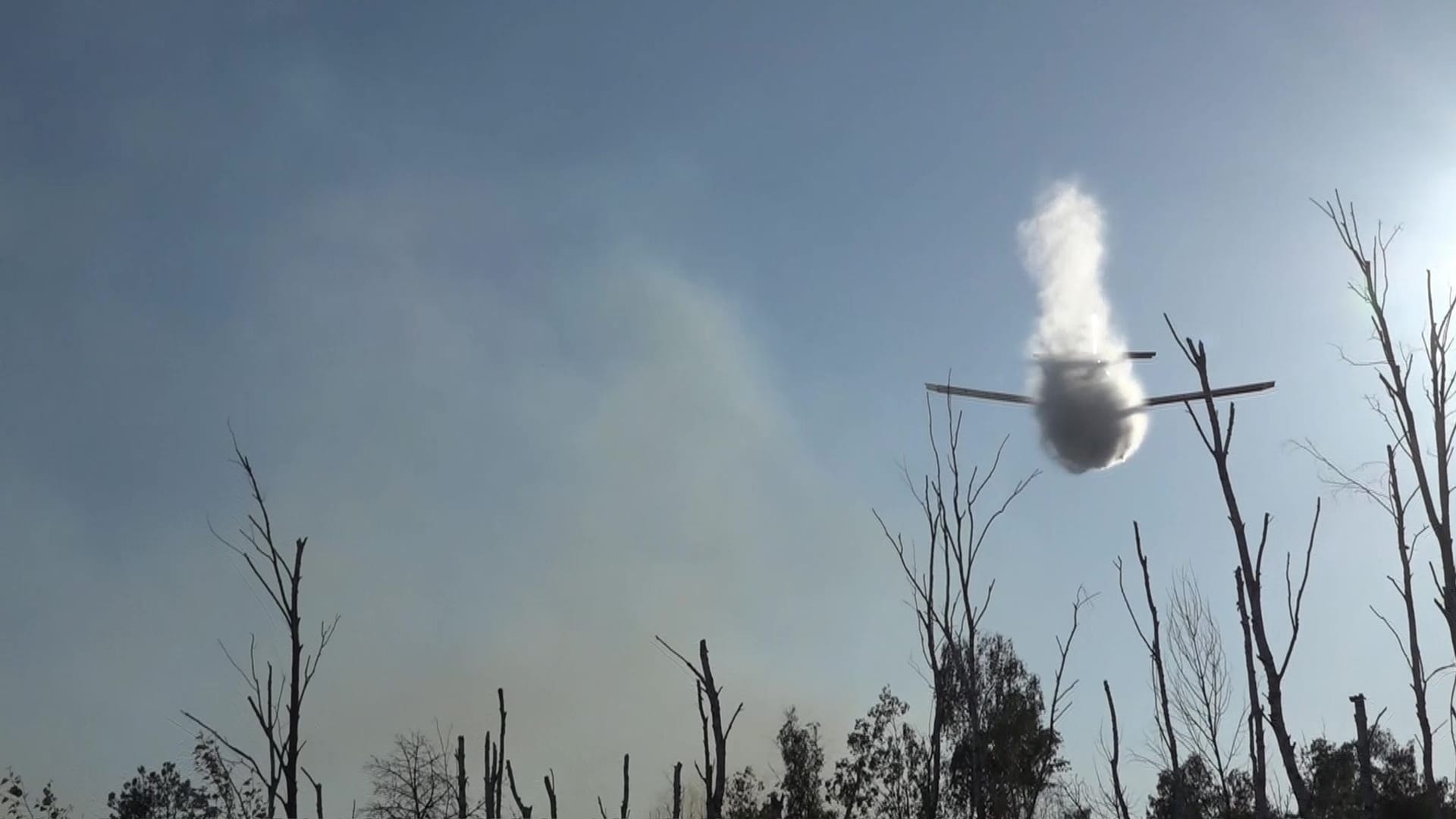 Löschflugzeug wirft Wasser über dem Waldbrand ab: Die Löschung gestaltet sich als schwierig.