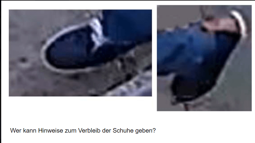 Es handelt sich um dunkle Herrenschuhe mit bräunlichem Fersenaufsatz, einer weißen Zwischensohle und weißen Schnürsenkeln.