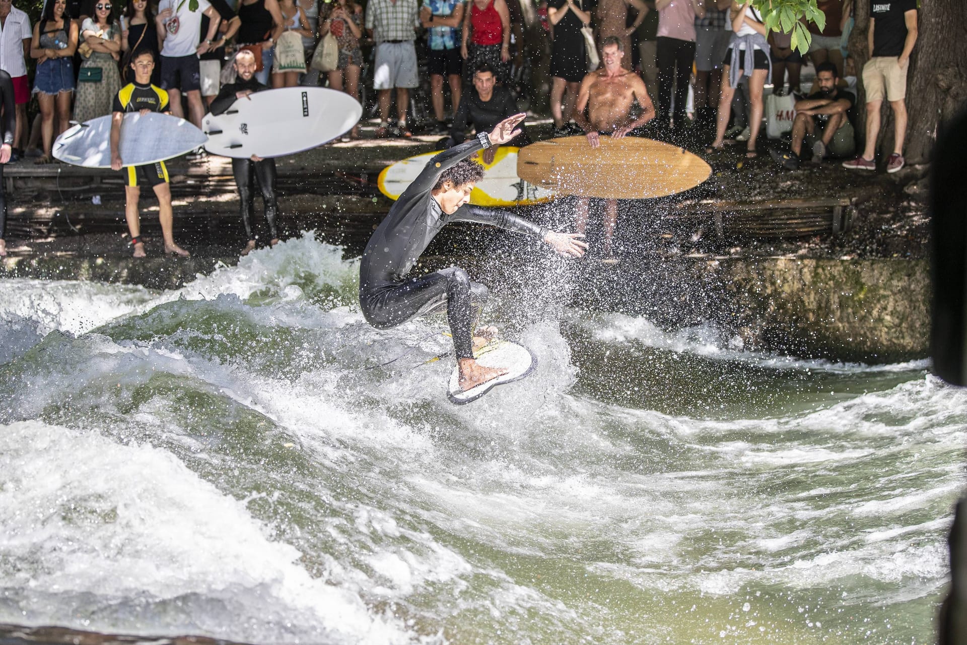 Ein Surfer auf der Eisbachwelle in München (Archivbild): In der bayerischen Landeshauptstadt wurde des Surfen am Festland erfunden.