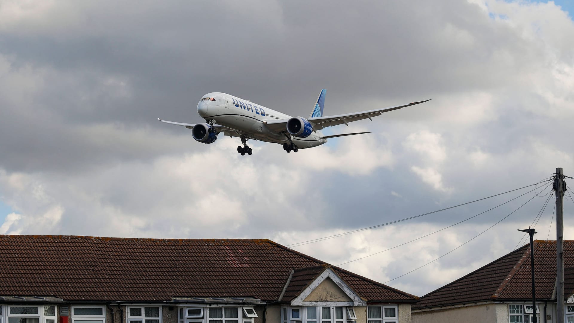 Ein Passagierflugzeug fliegt über Häuser (Symbolbild): Vorfälle mit Notrutschen gibt es wohl immer wieder mal.