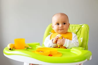Mit den ersten Zähnchen können Babys schon weiches Obst essen.