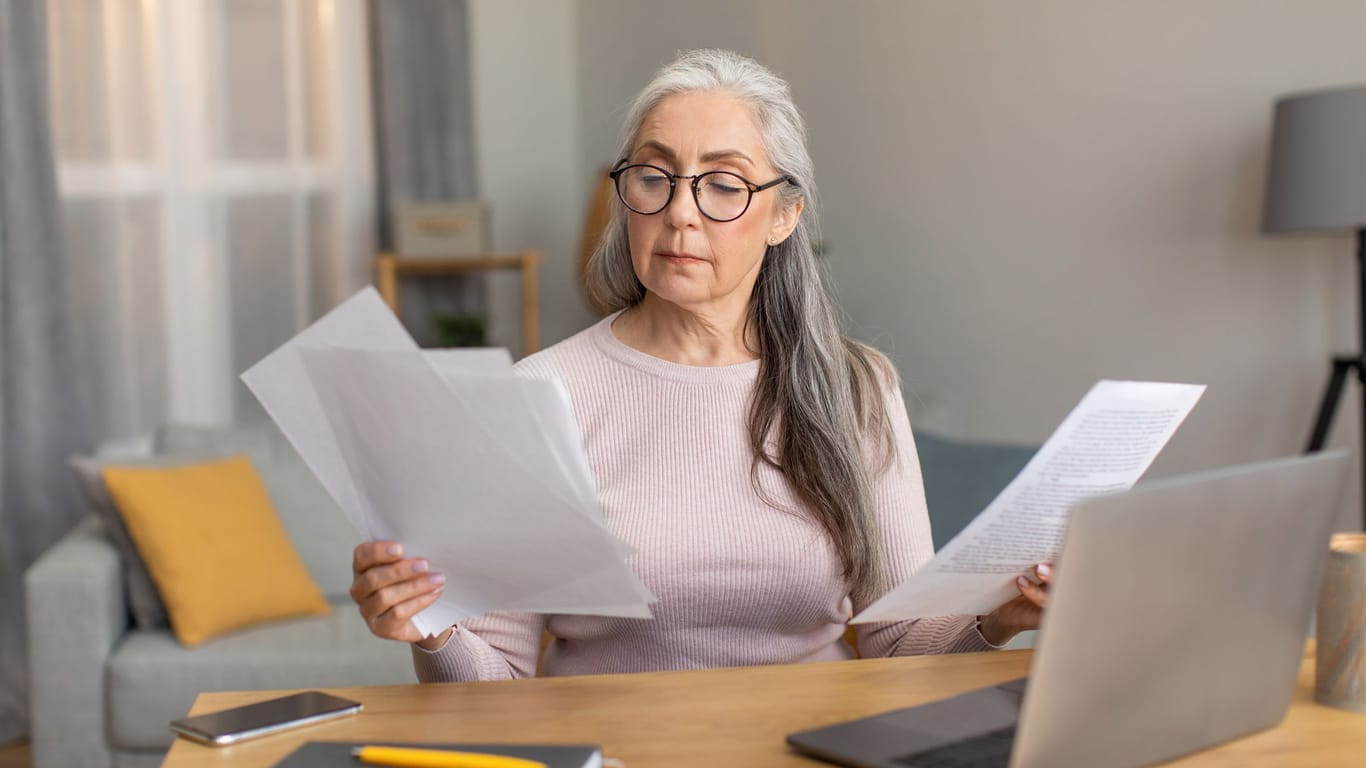 Rentnerin sichtet mehrere Dokumente: Für unterschiedliche Renten können unterschiedliche Steuerregeln gelten.