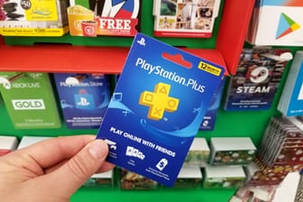 Play Station Plus gift card in a hand